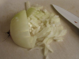 Finely chopped onion, the root still intact so the uncut part doesn't fall apart.