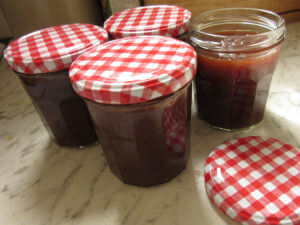 Jars freshly filled with rhubarb marmalade.